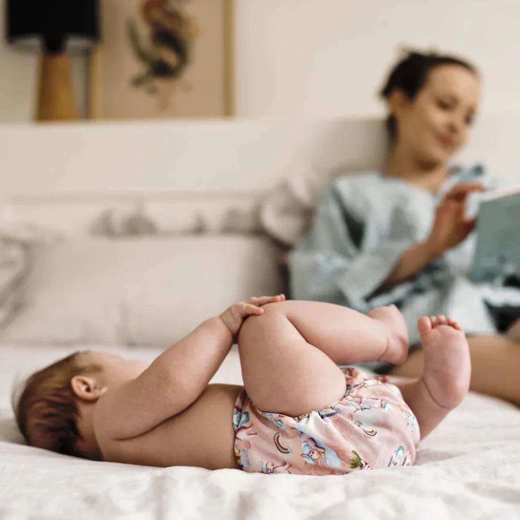 Bébé allongé portant une culotte d'apprentissage rose motif licornes, apprentissage de la propreté sans pression – Presque Grand